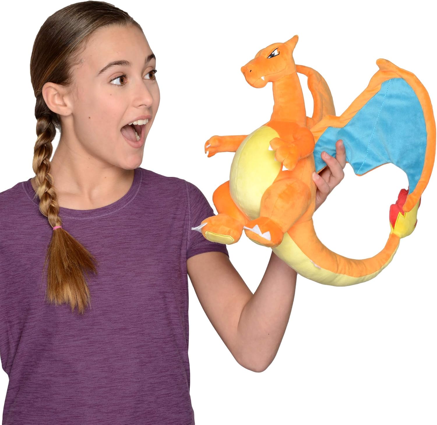 Person holding a colorful dragon-shaped toy Pokemon Charizard with a white background