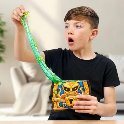Child playing with a green goo and treasure chest