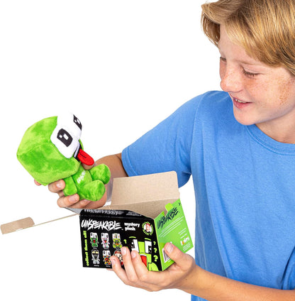 Child holding a green plush toy and its packaging with a white background