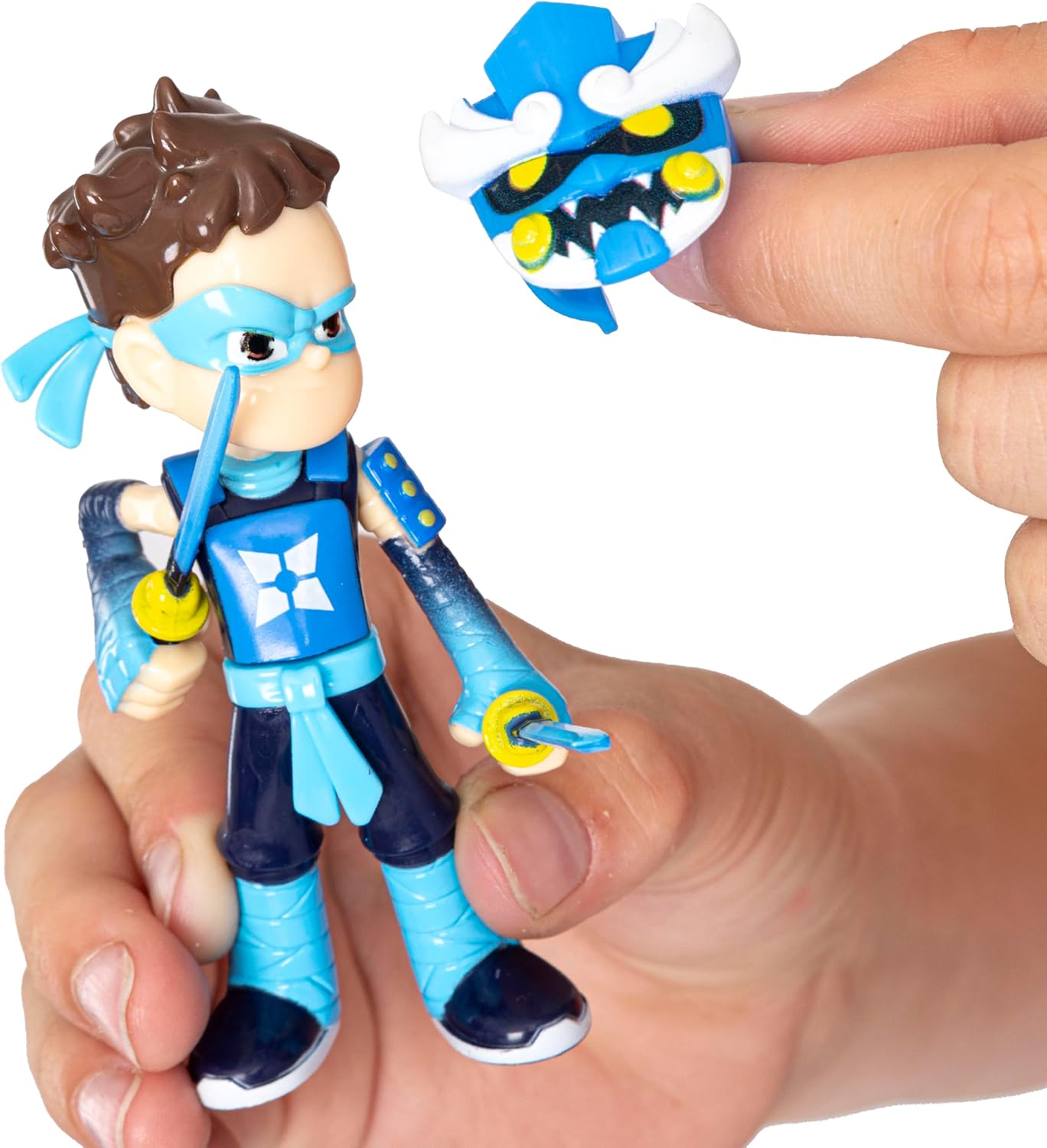 Toy figure with accessories held by a hand on a white background