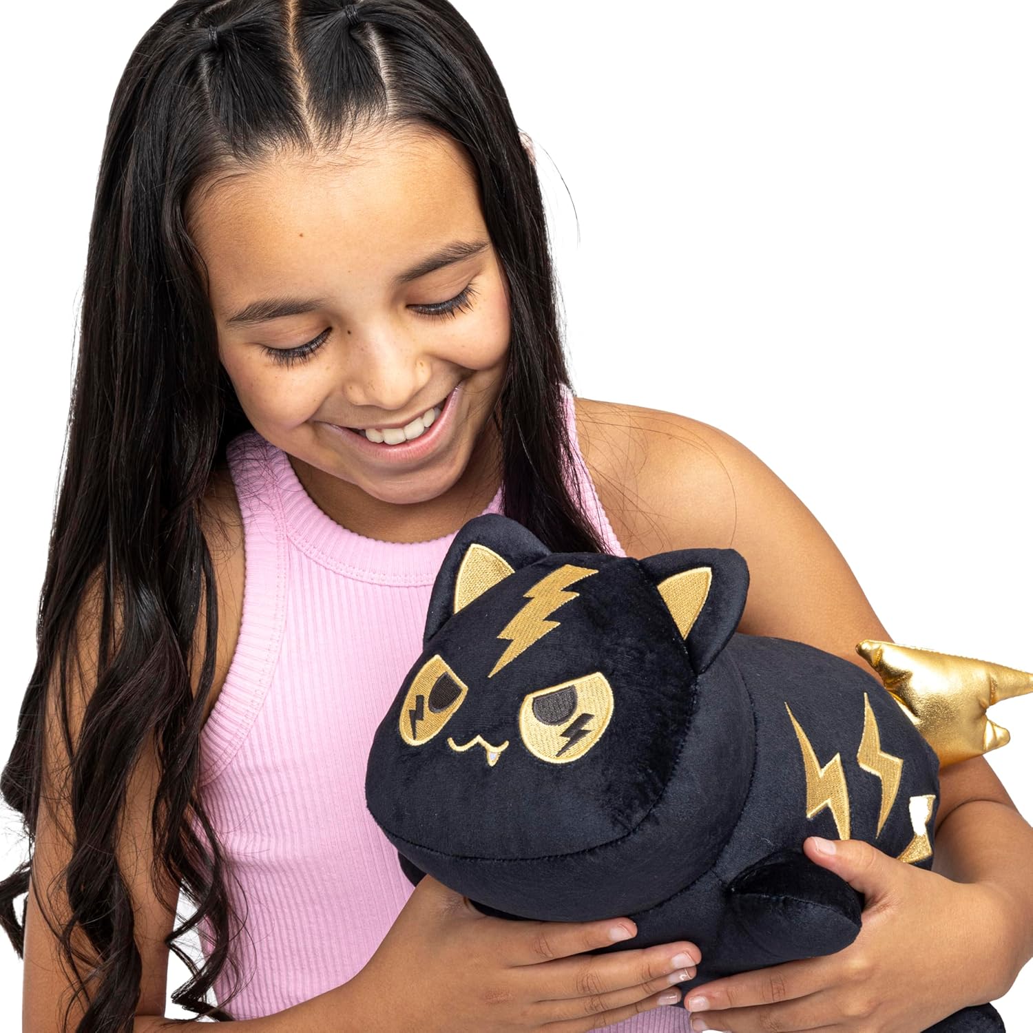 Young girl holding a black plush cat toy with gold accents on a white background