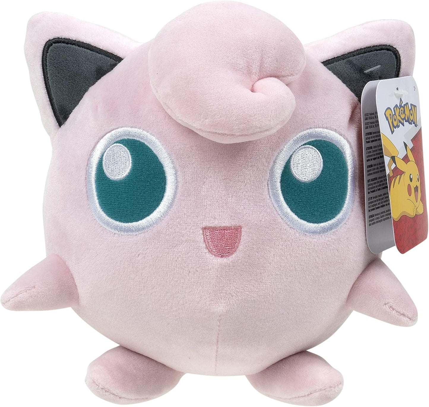 Plush toy Jigglypuff creature with large blue eyes and a tag on a white background