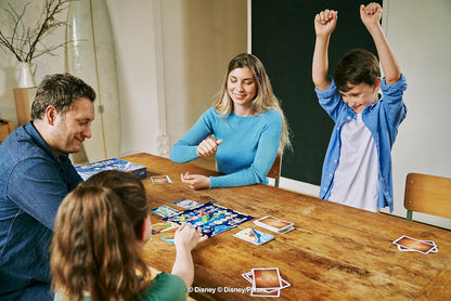 Family playing a board game together at a table