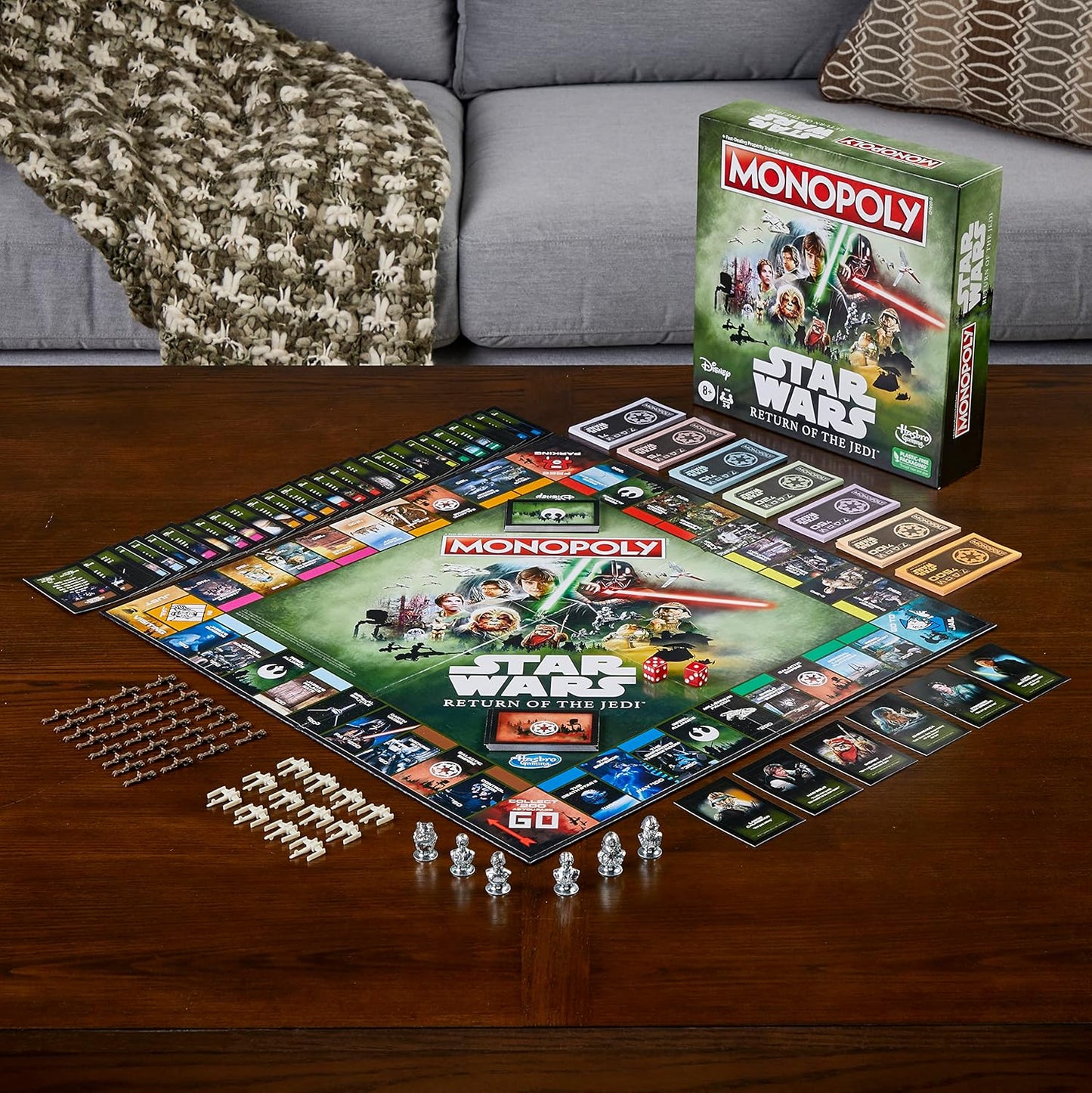 Star Wars Monopoly game set up on a wooden table with the game box in the background.