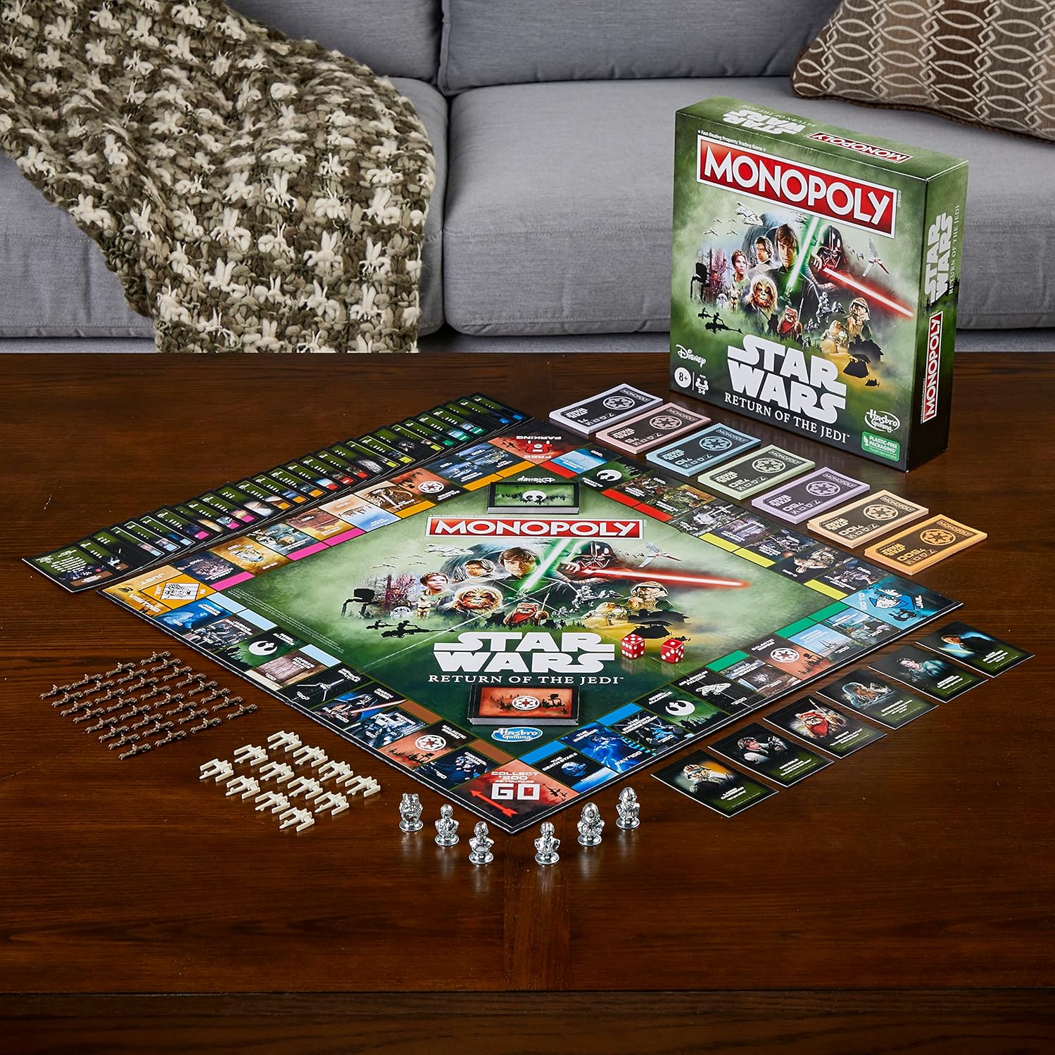 Star Wars Monopoly game set up on a wooden table with the game box in the background.