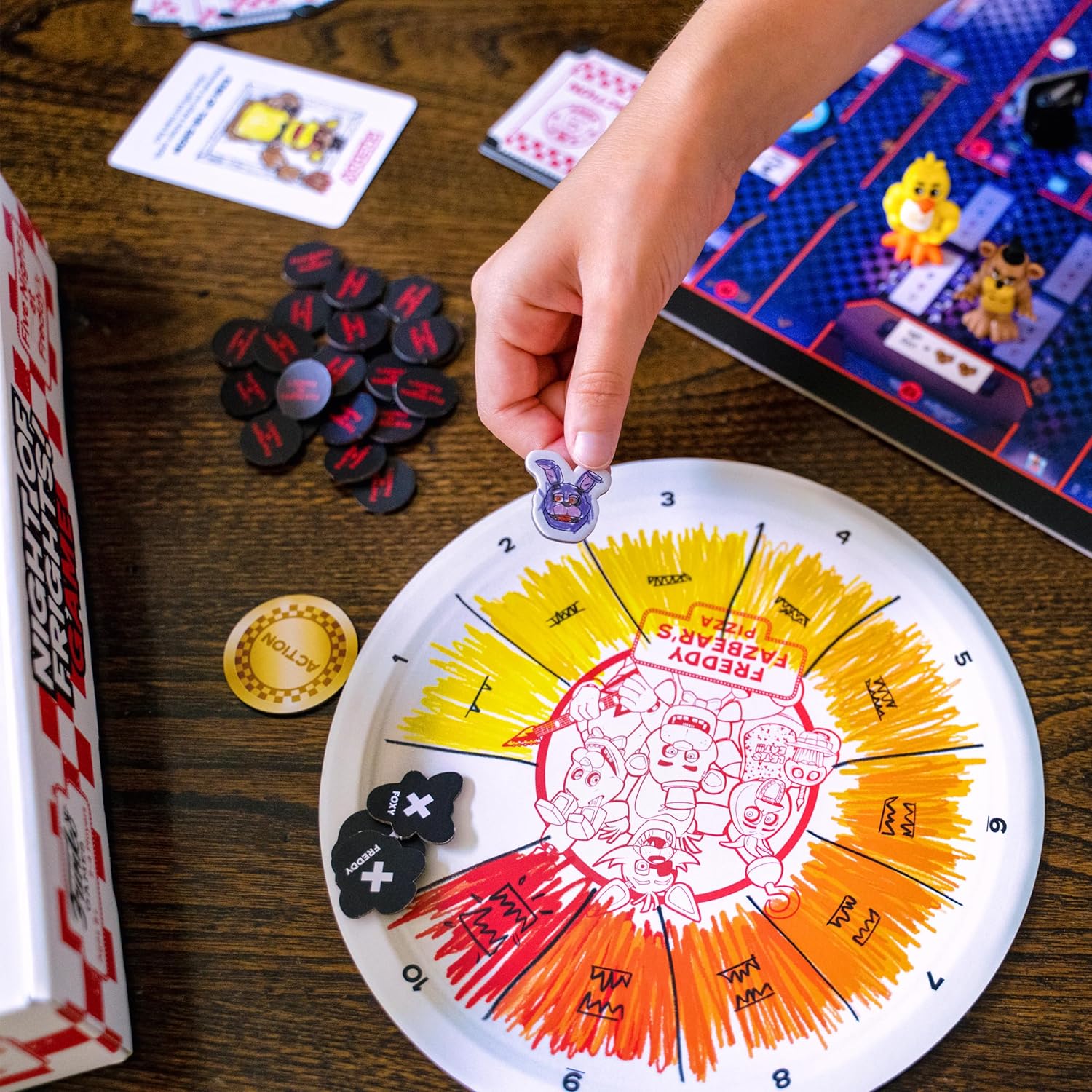 Board game with spinner and tokens on a wooden table