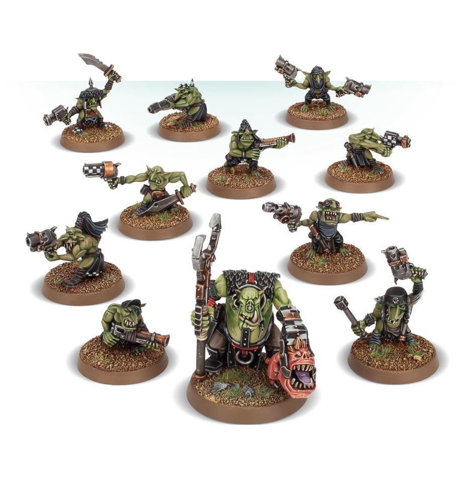 Set of green ogre figurines with various weapons on brown bases against a white background