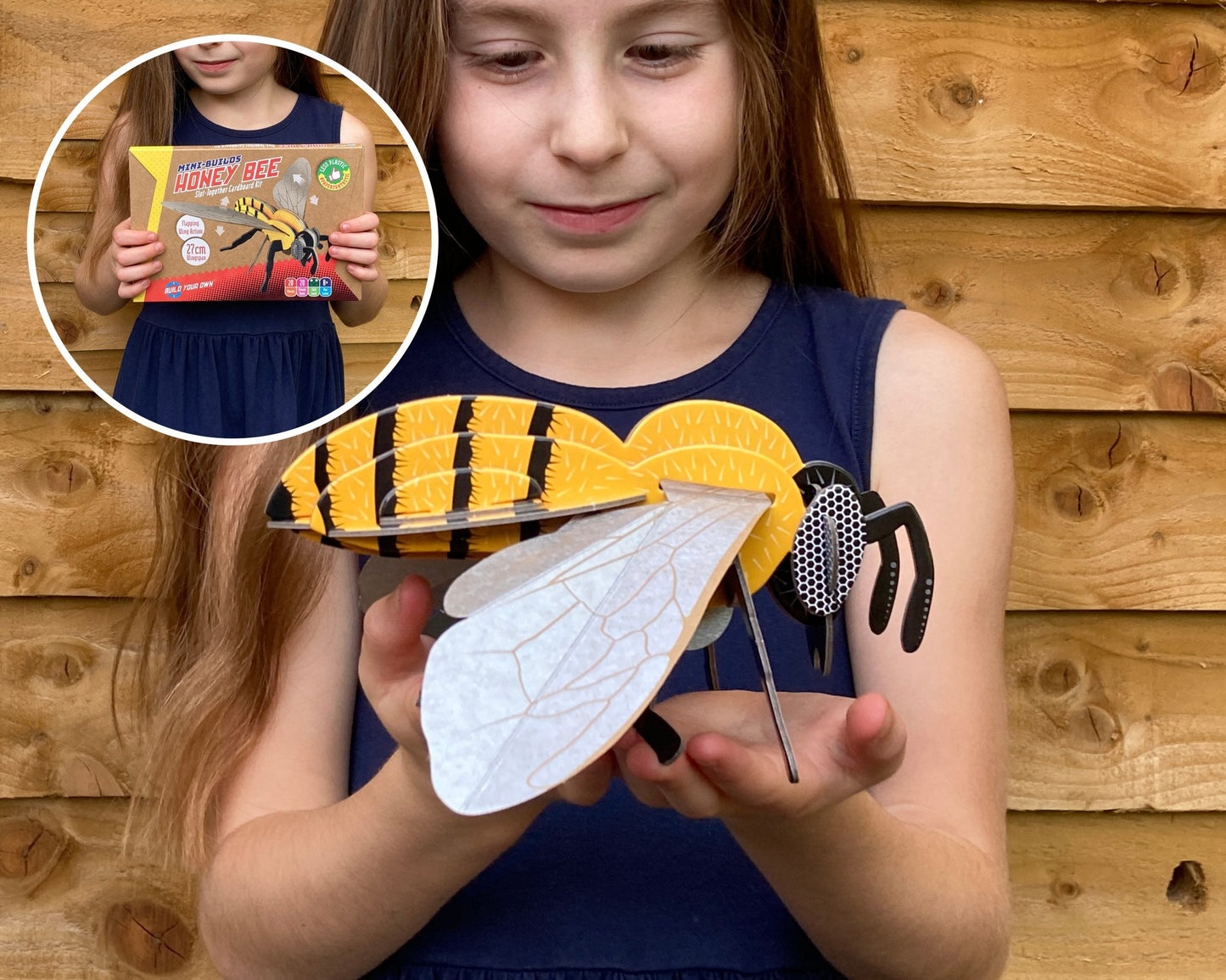 Girl holding a paper wasp model with inset showing a book titled 'Wasp'.