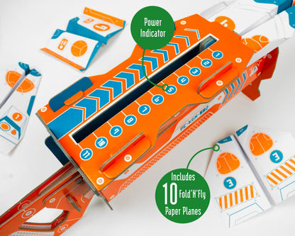 Orange and blue paper plane kit with power indicator and included paper planes on a white background