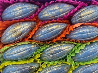 Blue cocoa beans in colourful paper packaging