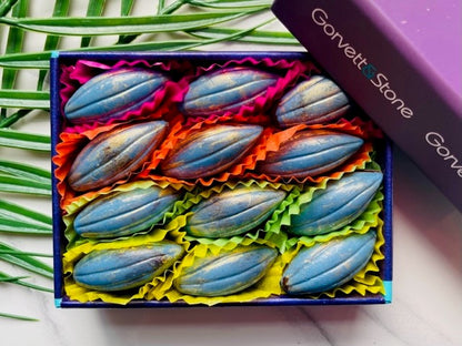 Box of blue candies with colourful wrappers on a white surface, branded 'Garveit & Stone'.