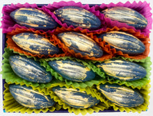 Box of chocolates with colourful paper liners on a white background