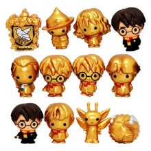 Collection of Harry Potter-themed figurines with gold and black attire on a white background