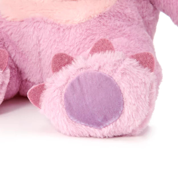 Close-up of a pink plush toy with purple accents on a white background