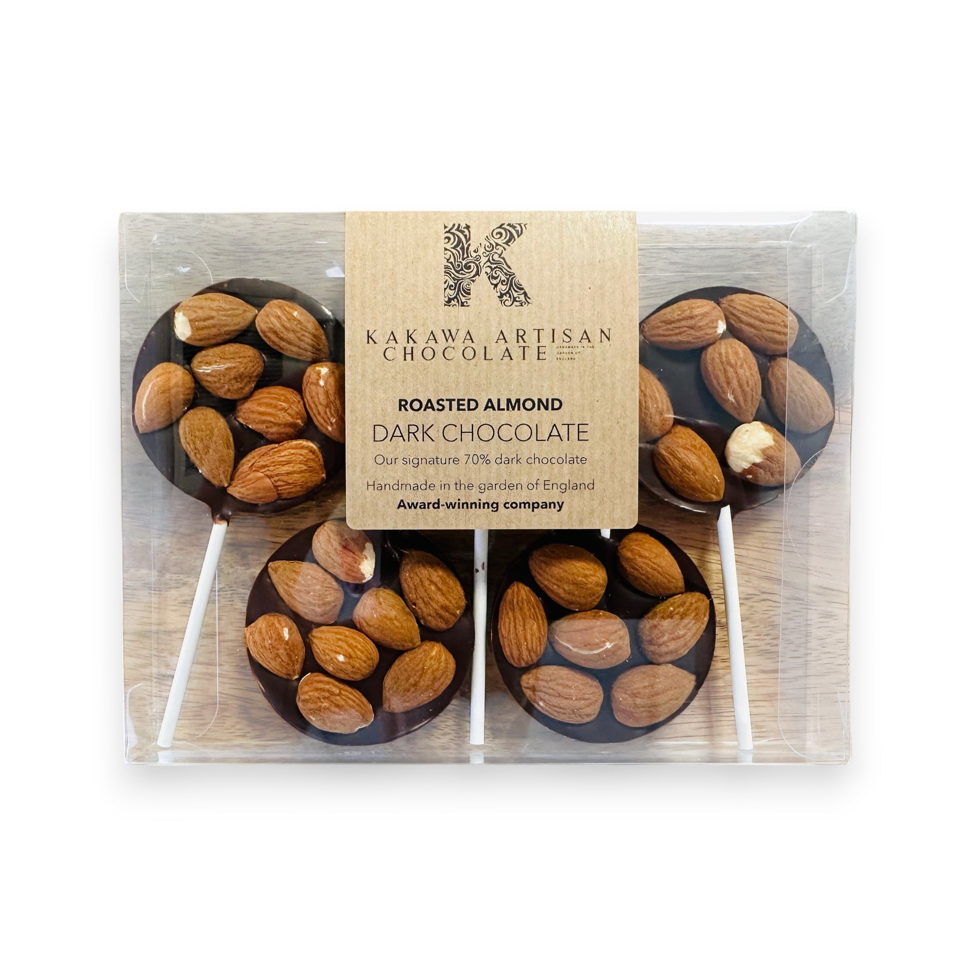Dark chocolate lollipops with almonds in a Kakawa Artisan Chocolate packaging.