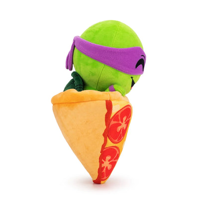 TMNT Plush toy resembling a green turtle with a purple shell inside a taco on a white background