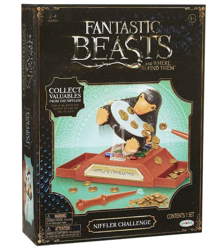 Box for 'Fantastic Beasts' Niffler Challenge game with a penguin and gold coins on a white background.