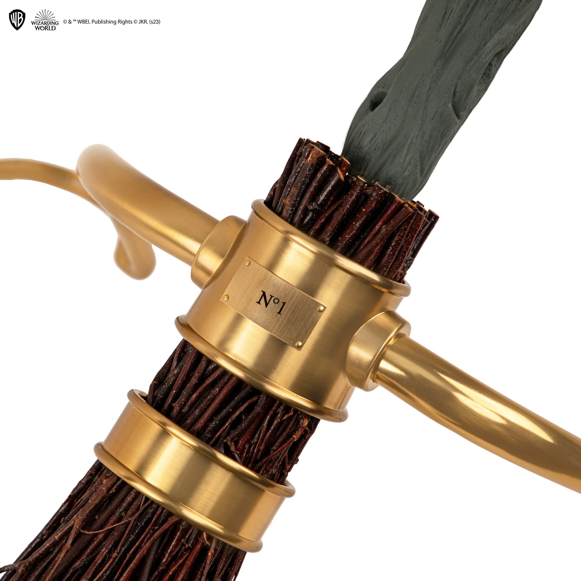 Gold-handled brush with bristles on a white background