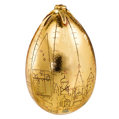 Gold egg-shaped chocolate with engravings on a white background