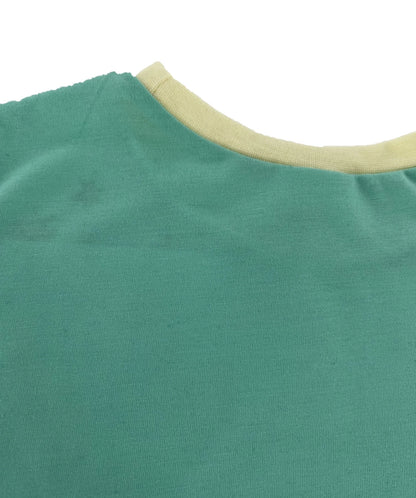 Close-up of a green shirt with beige collar on a white background