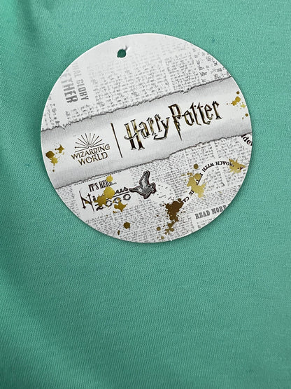 Round Harry Potter-themed product on a green background