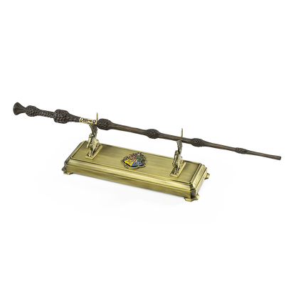 Harry Potter wand on a gold stand with a crest emblem on a white background