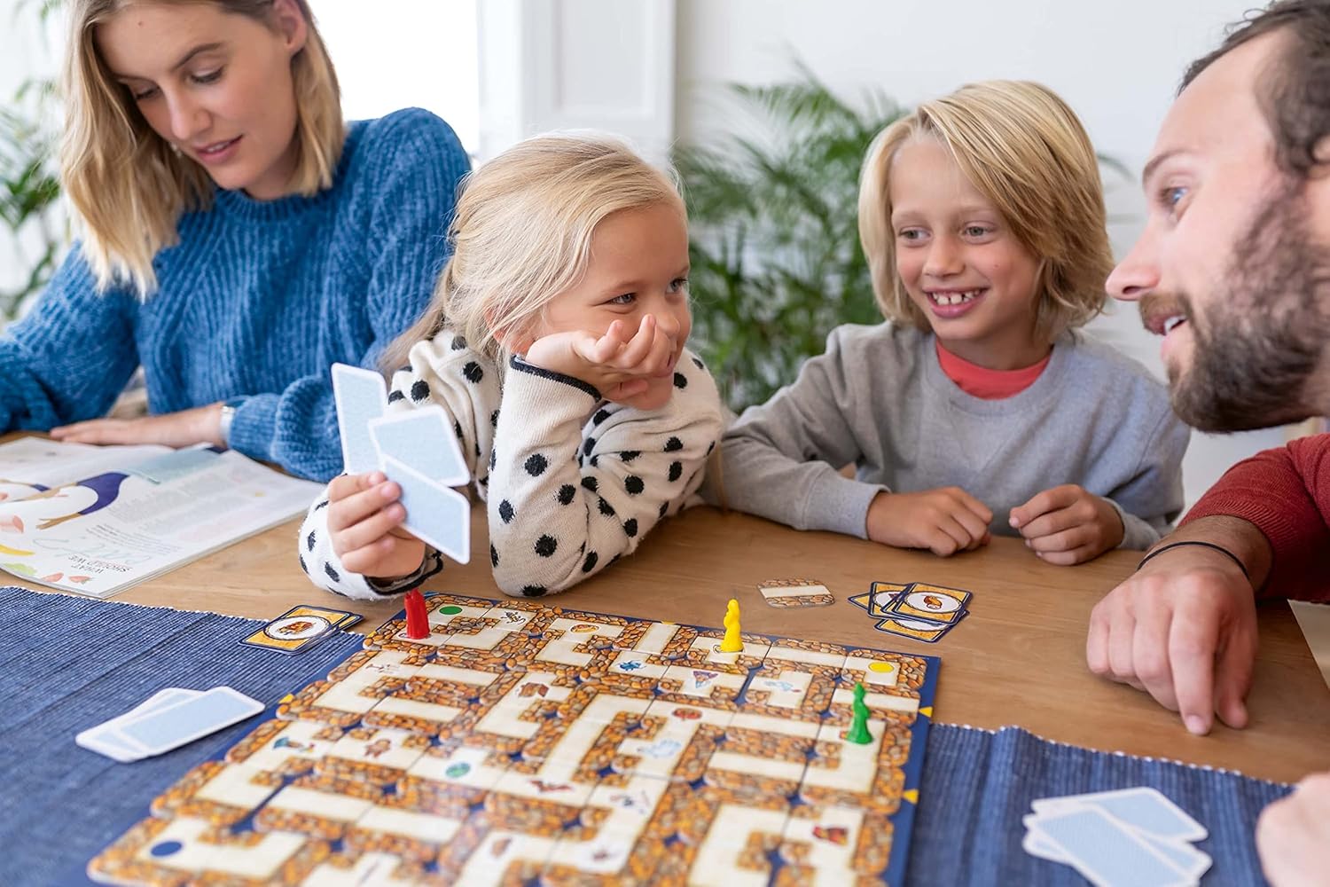 Family playing a board game together at a table