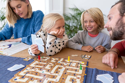 Family playing a board game together at a table