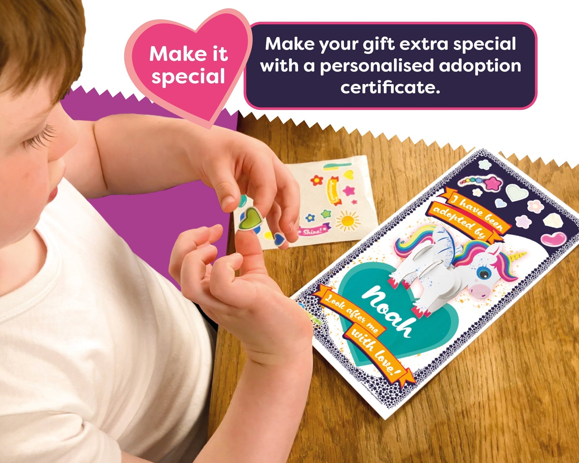 Child holding a personalized adoption certificate with a unicorn design on a wooden surface.