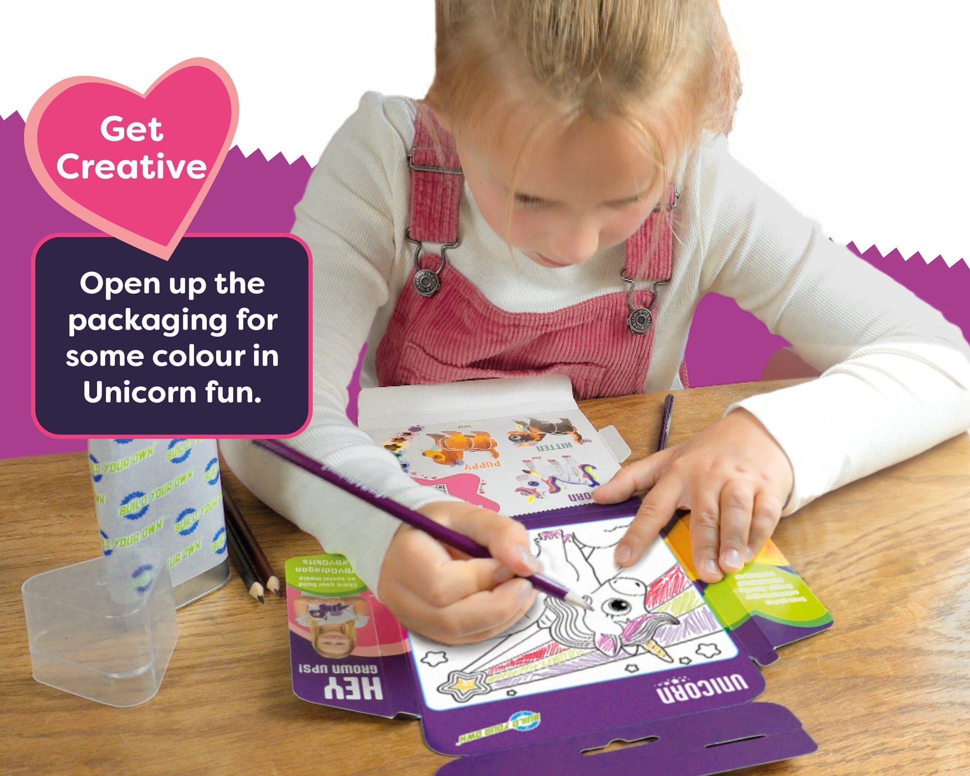 Child coloring a unicorn picture with a coloring book on a table, promotional text overlay.