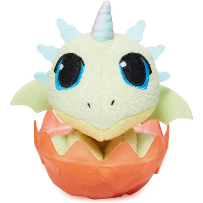 Plush dragon toy with blue horns and eyes, inside an orange egg on a white background