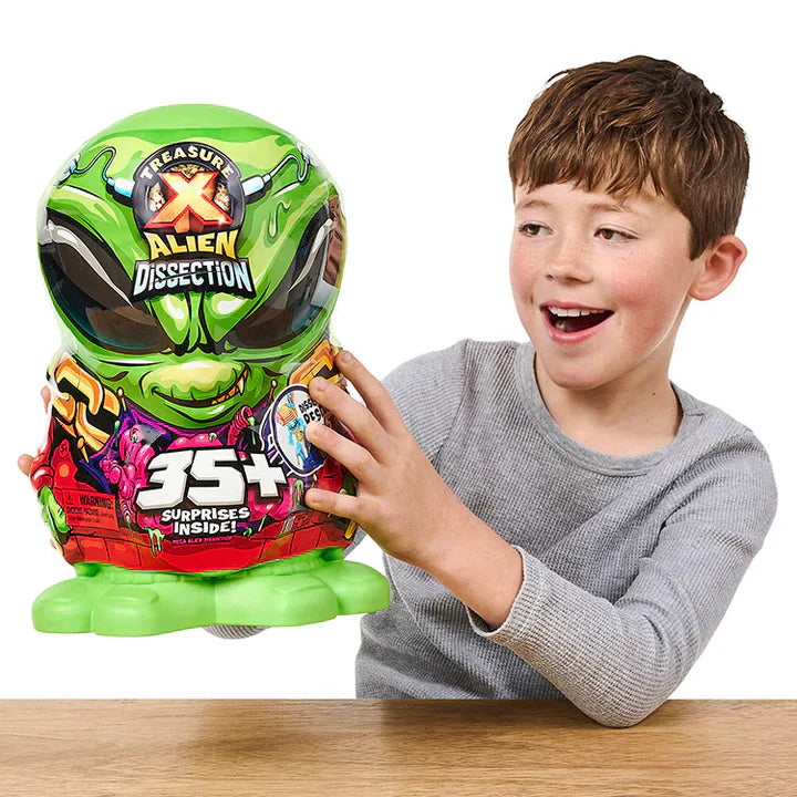 Child holding a toy with green alien design and text on a white background
