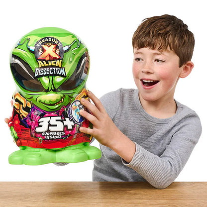Child holding a toy with green alien design and text on a white background