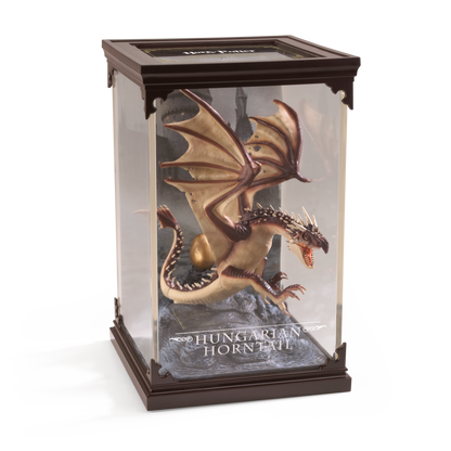 Model of a Hungarian Horntail dragon in a display case with 'Harry Potter' branding.