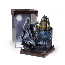Statue of a Dementor figure with a castle in the background on a white background