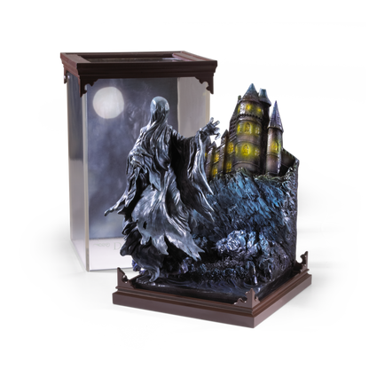 Statue of a Dementor figure with a castle in the background on a white background