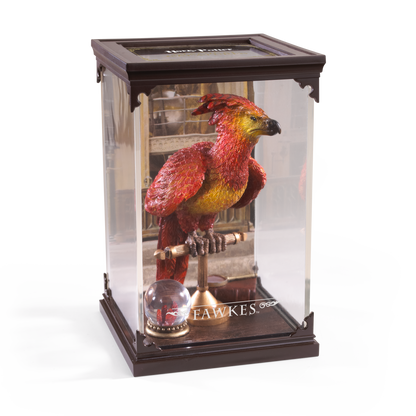 Model of a phoenix bird in a glass display case with 'Harry Potter' branding.