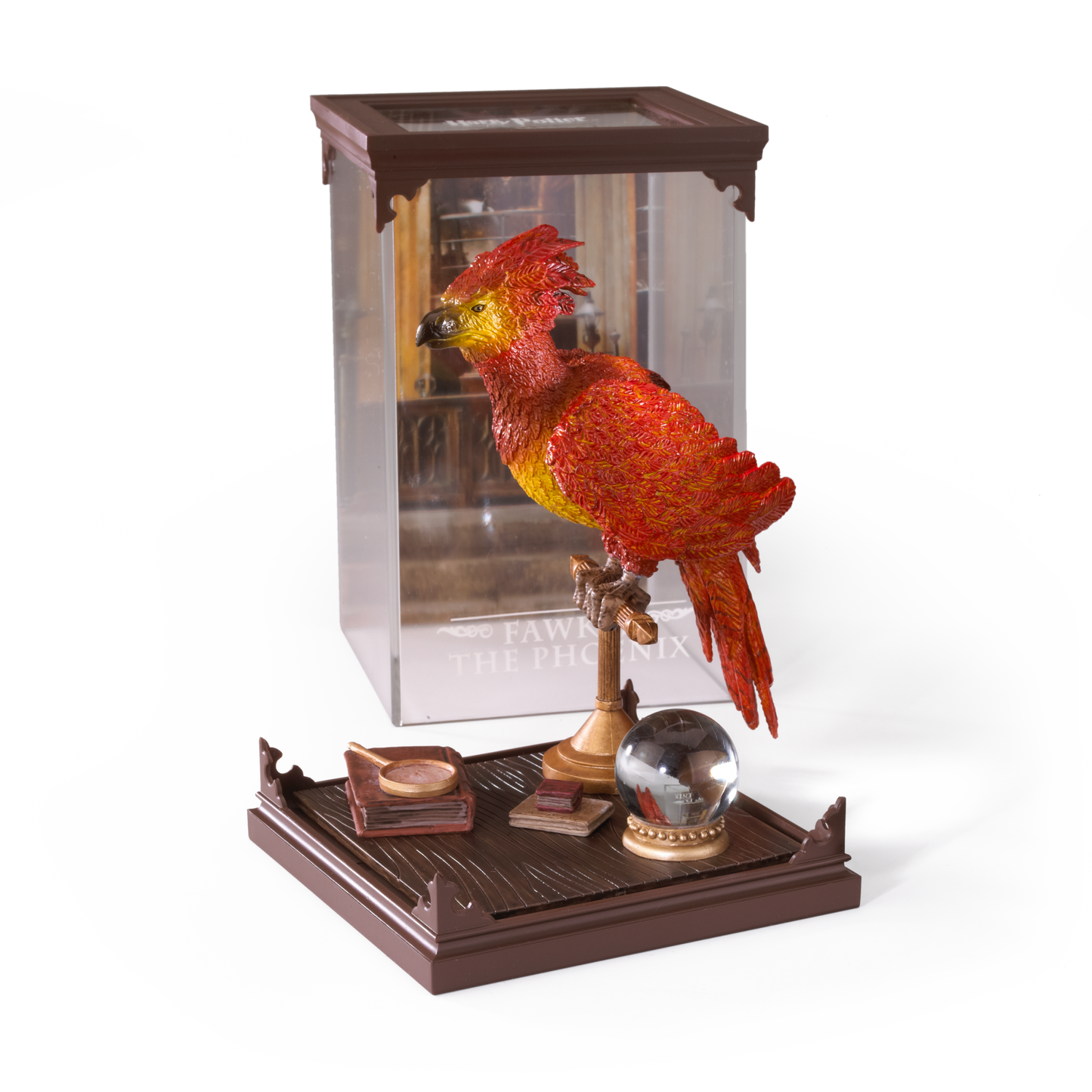 Decorative Fawkes figurine in a plastic case on a wood effect base with a white background