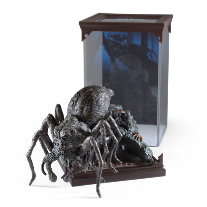 Detailed Aragog figurine in front of a glass display case with a dark interior.