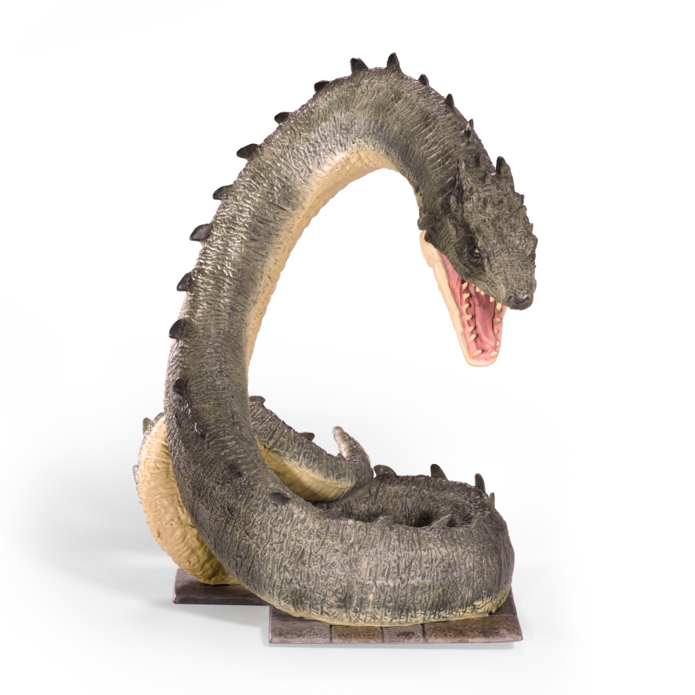 Basilisk figurine with open mouth on a white background
