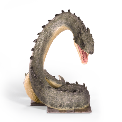 Basilisk figurine with open mouth on a white background