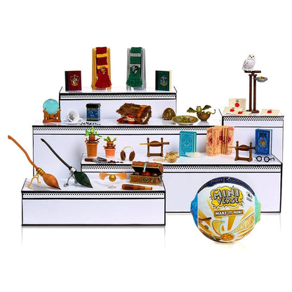 Miniature model of a store shelf with various items on a white background