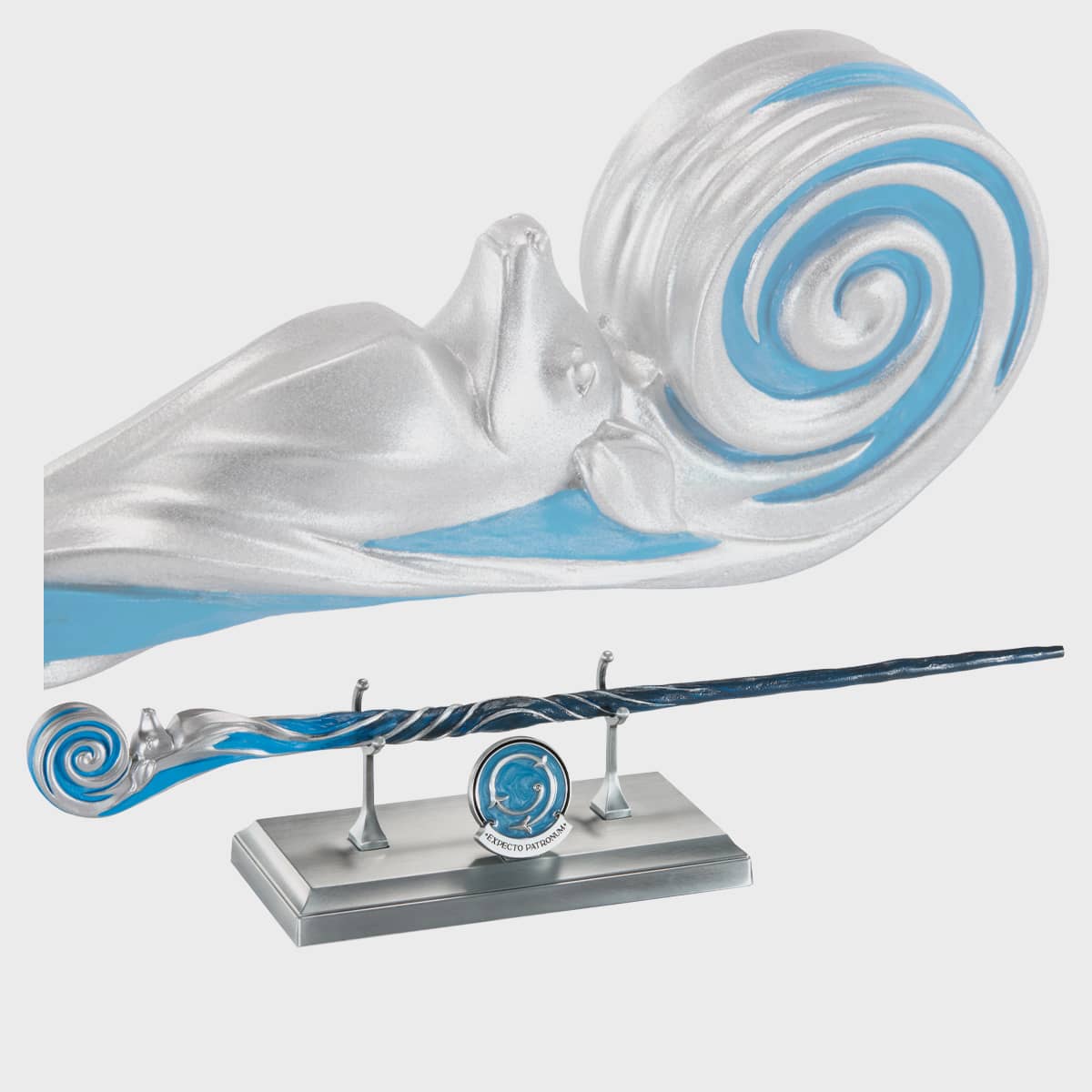 Decorative wand with a Expecto Patronum on a stand against a white background