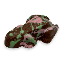 Chocolate candy shaped like a fish with green and pink patterns on a white background