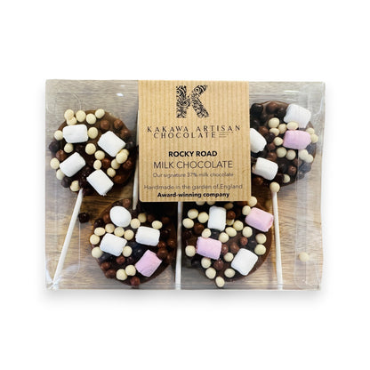 Packaged rocky road milk chocolate lollipops with a Kakawa Artisan Chocolate box.
