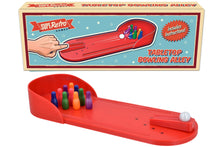 Tabletop bowling alley game with packaging on a white background