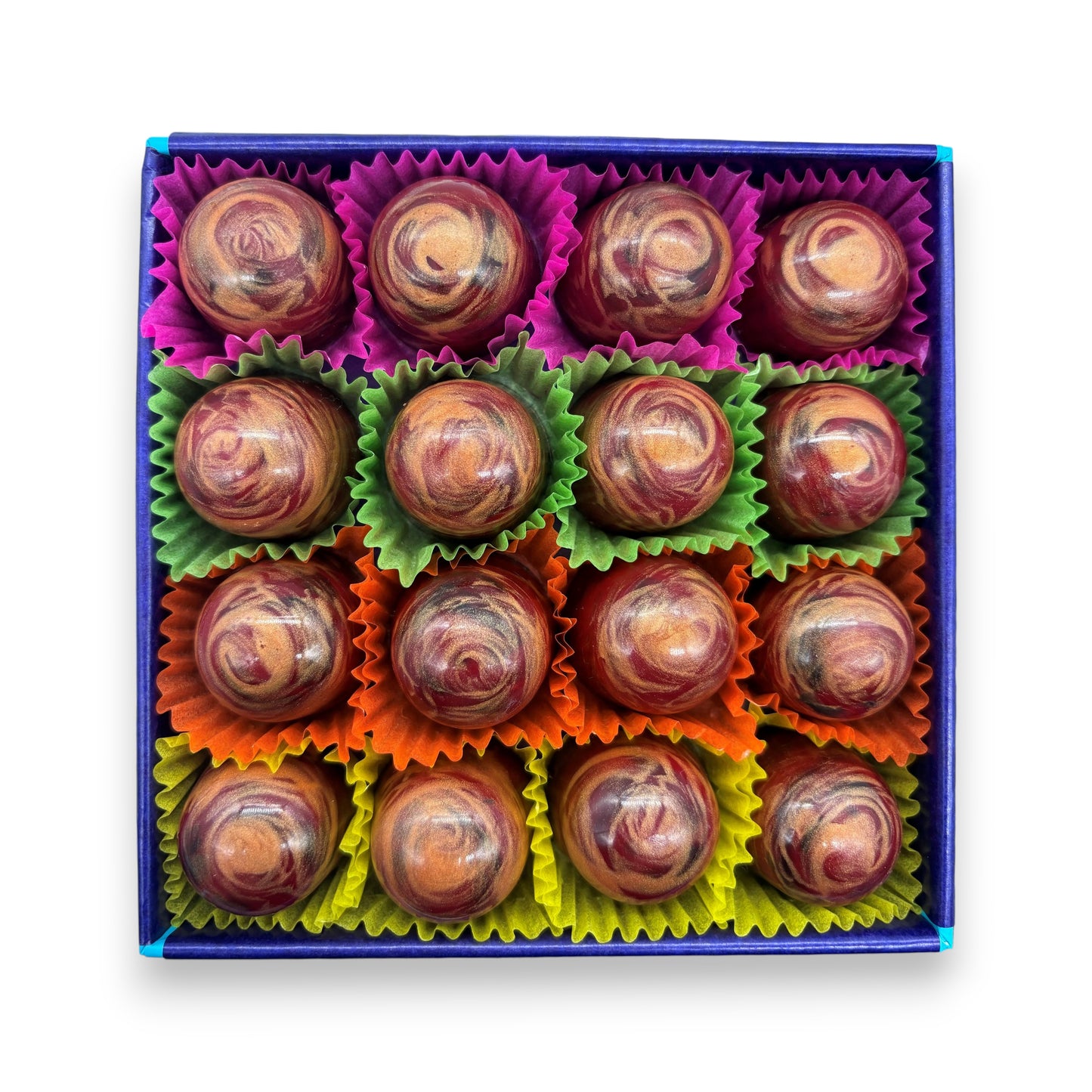 Box of chocolates with colourful wrappers on a white background