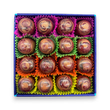 Box of chocolates with colourful wrappers on a white background