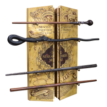 Four wizarding wands displayed against a book with 'Harry Potter' design