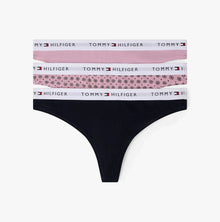 Black thong with floral and solid color waistbands on a white background, featuring Tommy Hilfiger branding.